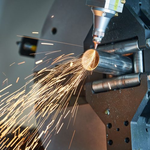 Fiber laser tube cutting machine cutting metal pipes with sparks